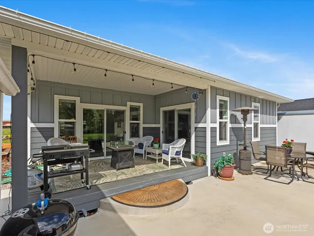 a view of a house with backyard porch and sitting area