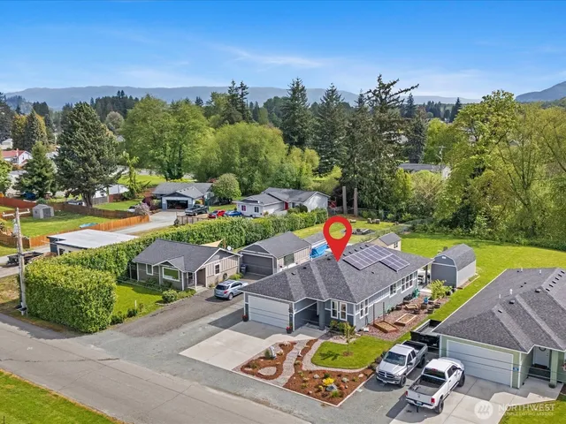 an aerial view of a house with garden space and street view