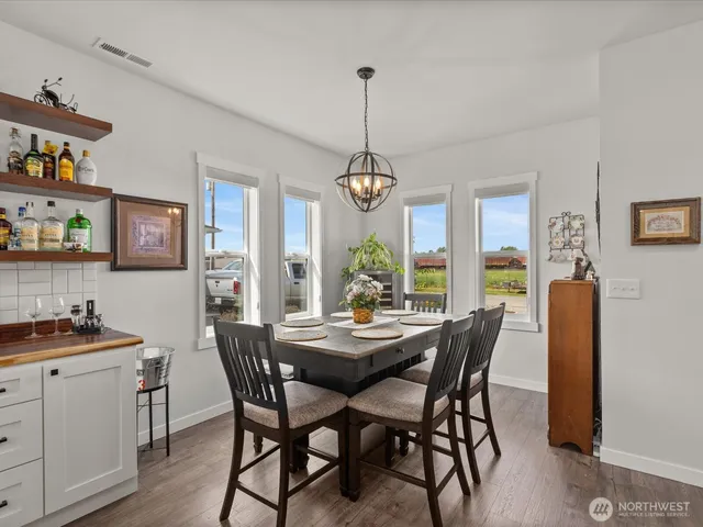 a dining room with furniture a chandelier and window