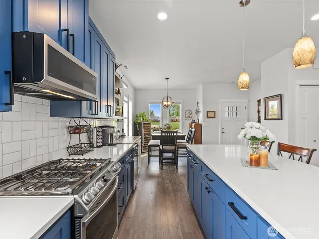 a kitchen with lots of counter top space and wooden floor