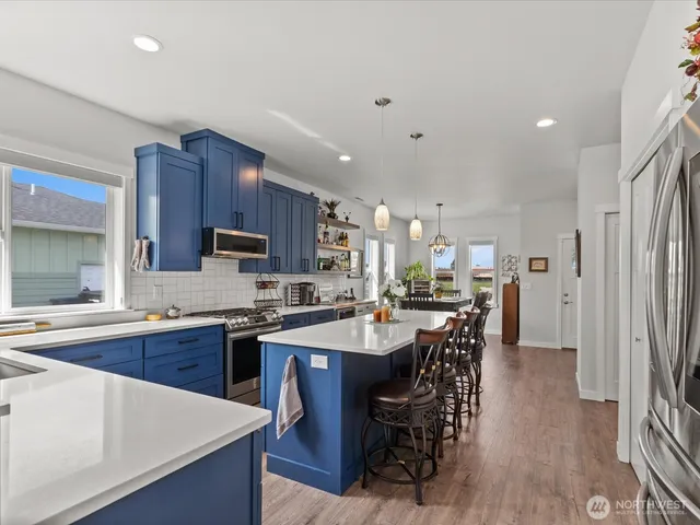 a large kitchen with a table and chairs