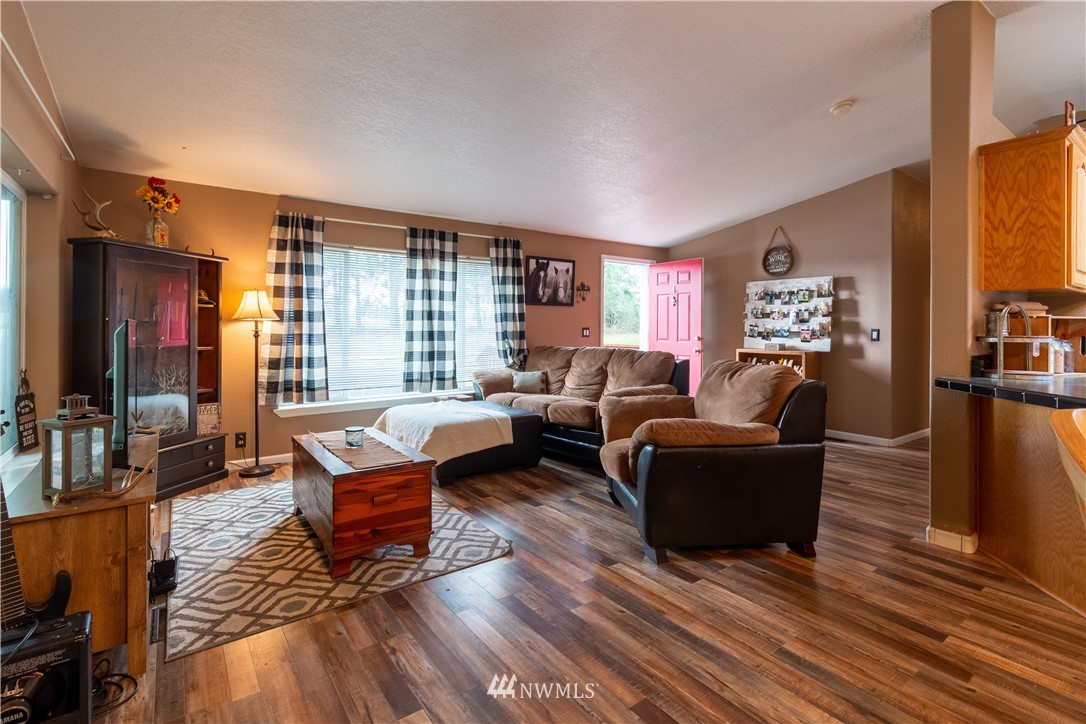 176 Nelson Road Winlock, WA 98596 - Photo 2 of 16 a living room with fireplace furniture and a wooden floor