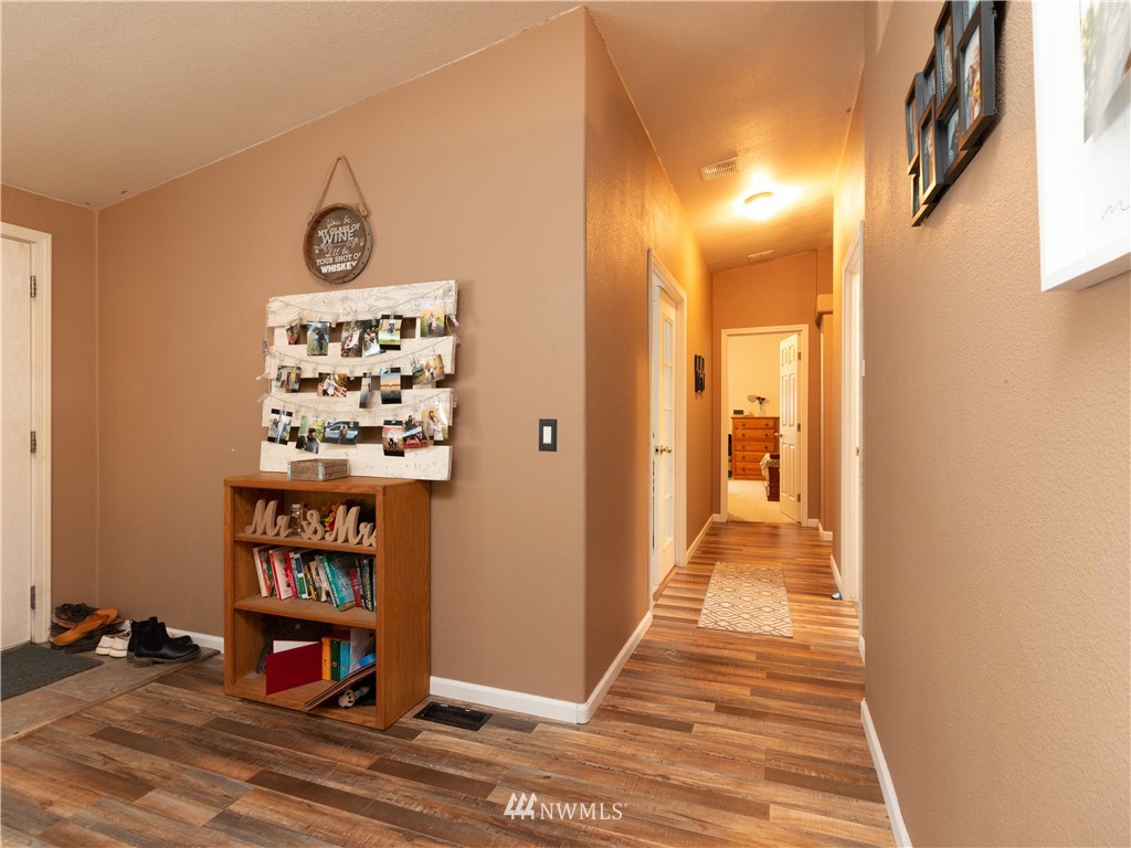 176 Nelson Road Winlock, WA 98596 - Photo 6 of 16 a view of a hallway to a house with wooden floor