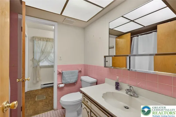 a kitchen with a sink a counter top space stainless steel appliances and cabinets