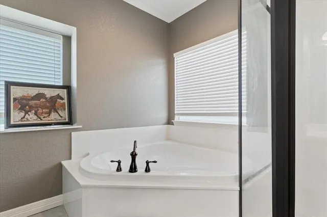 a bathroom with a bathtub and a window