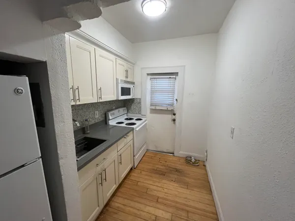 a kitchen with a sink and a stove top oven