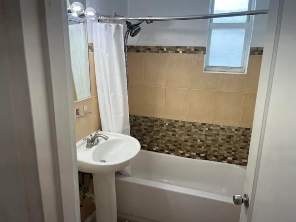 a bathroom with a sink and shower
