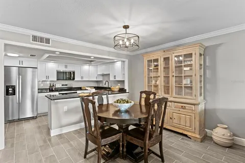 a view of a dining room with furniture large window and wooden floor