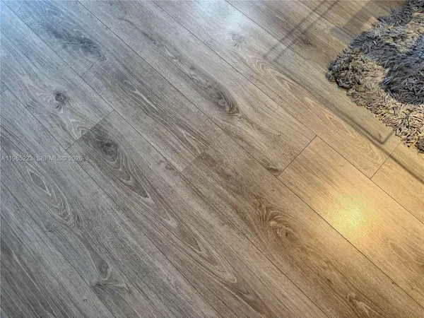 a kitchen with granite countertop cabinets stainless steel appliances a sink and dishwasher with wooden floor