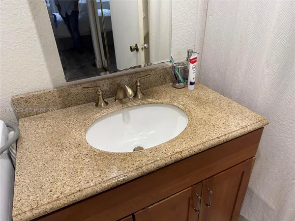 a bedroom with a bed a large window and a couch