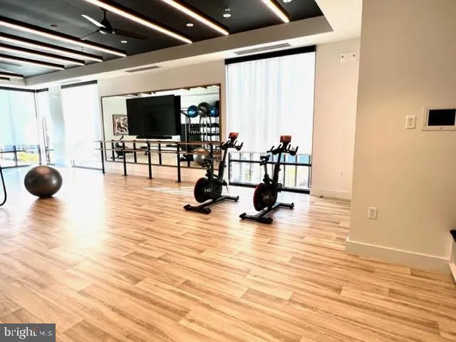 a living room with furniture a flat screen tv and a large window