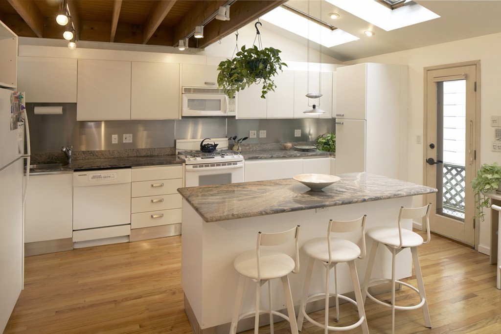 30 Inman Street, Unit C Cambridge, MA 02139 - Photo 4 of 8 a kitchen with granite countertop stainless steel appliances a sink and cabinets