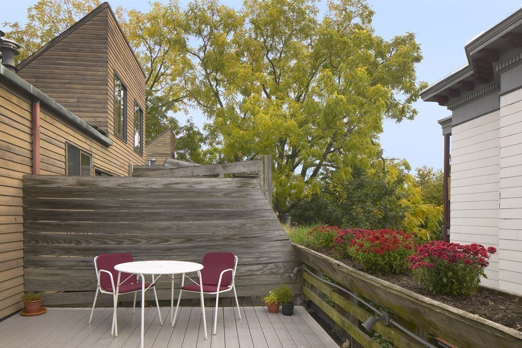 30 Inman Street, Unit C Cambridge, MA 02139 - Photo 6 of 8 a backyard with table and chairs and potted plants