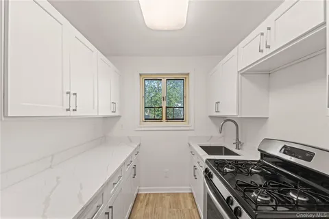 a kitchen with a stove and a white cabinets
