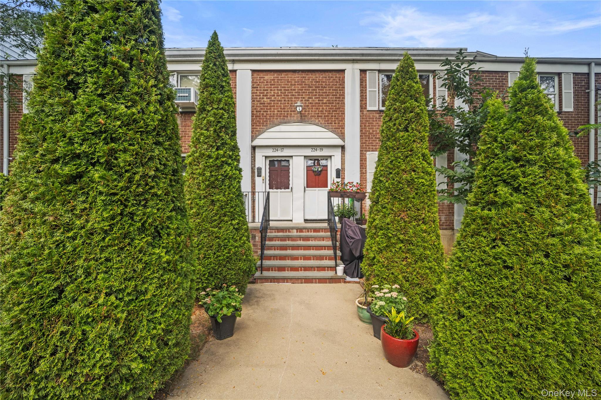 224-17 Manor Road, Unit LOWR Queens, NY 11427 - Photo 15 of 16 a front view of a house with a yard