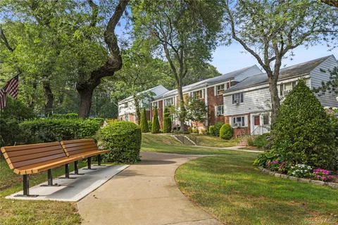 a front view of a house with a yard table and chairs