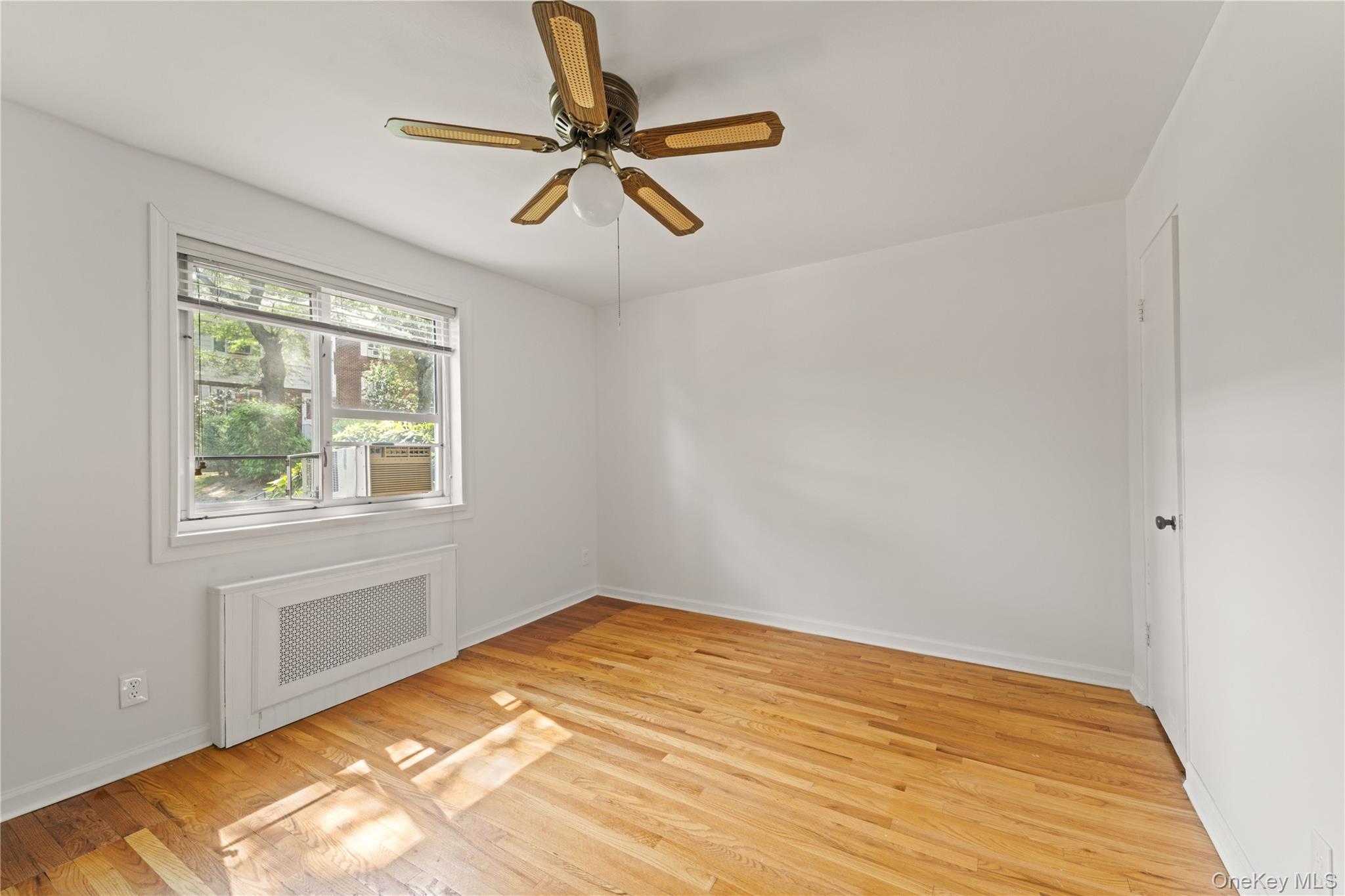 224-17 Manor Road, Unit LOWR Queens, NY 11427 - Photo 6 of 16 a view of empty room with wooden floor and fan