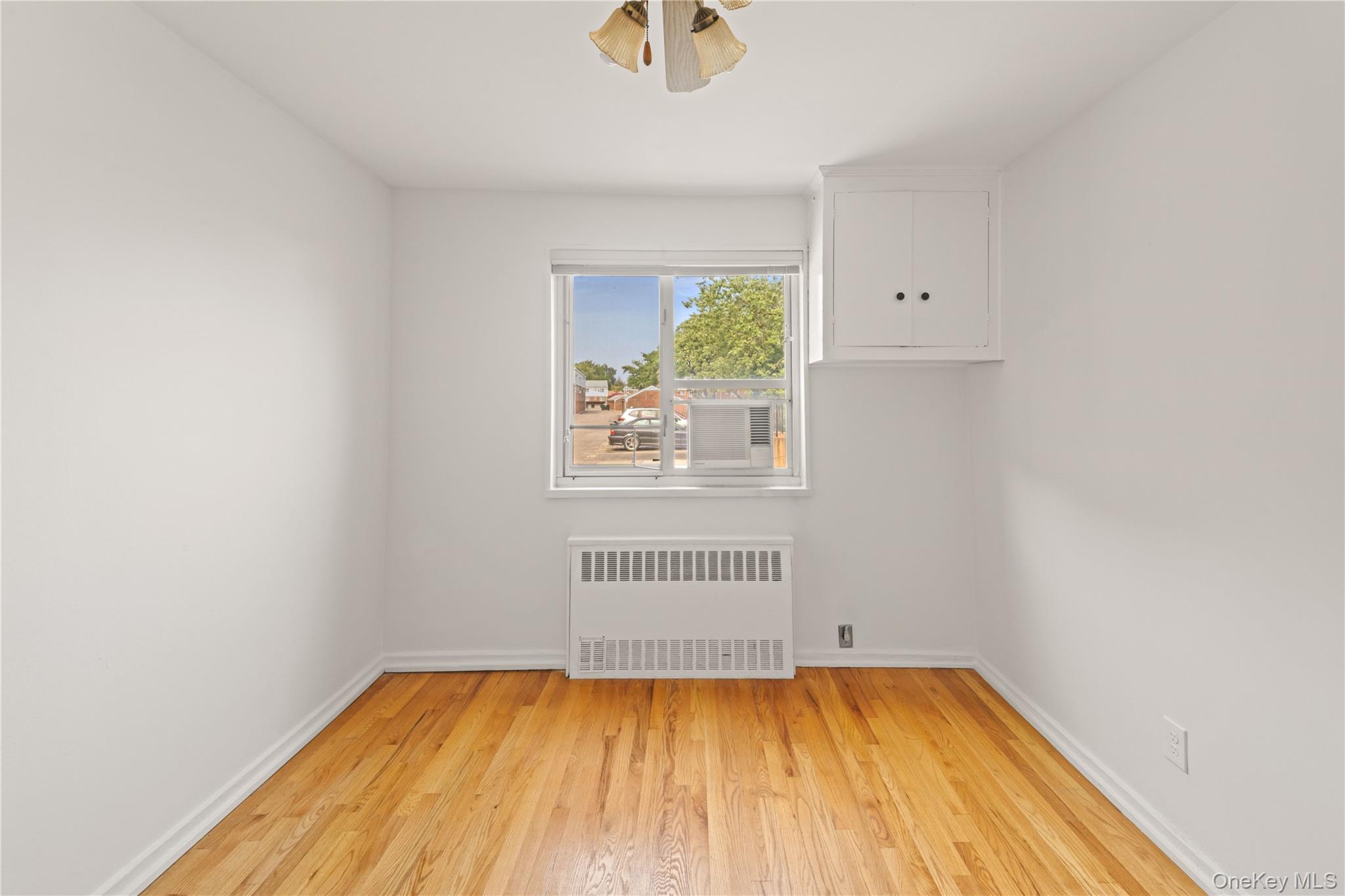 224-17 Manor Road, Unit LOWR Queens, NY 11427 - Photo 9 of 16 a view of a room with wooden floor and a window