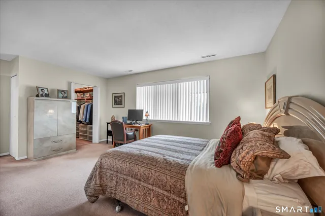 a bedroom with a large bed and a closet