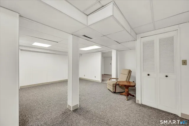 a view of a livingroom with furniture and gym equipment