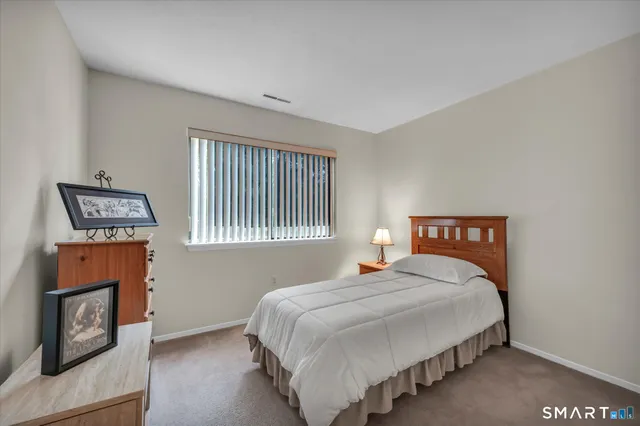 a bedroom with a bed and a night stand