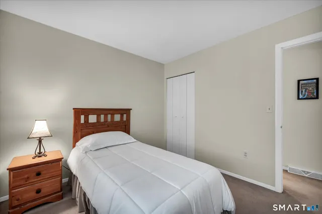 a bedroom with a bed and a night stand