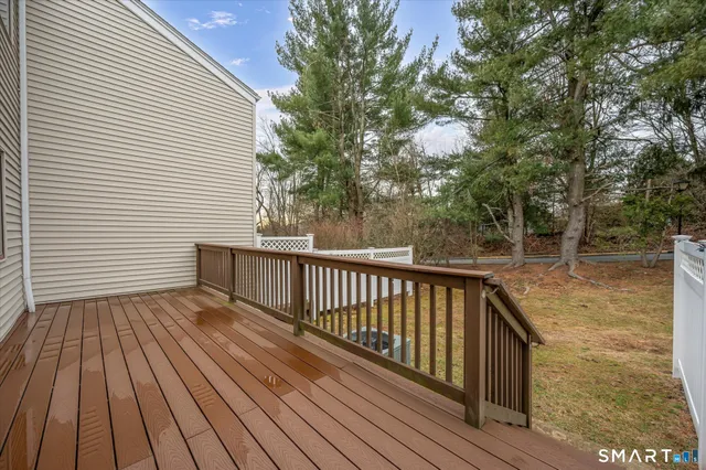 a view of balcony with wooden floor and fence