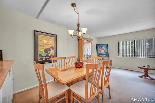 a view of a dining room with furniture and a chandelier