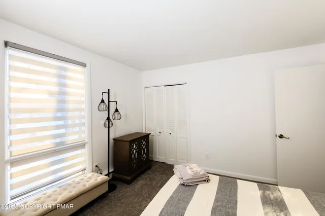 a view of a bedroom with window and a bathroom