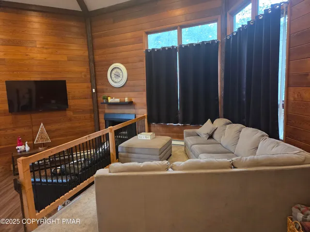 a living room with furniture wooden floor and a window
