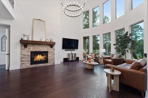 a living room with fireplace furniture and a large window
