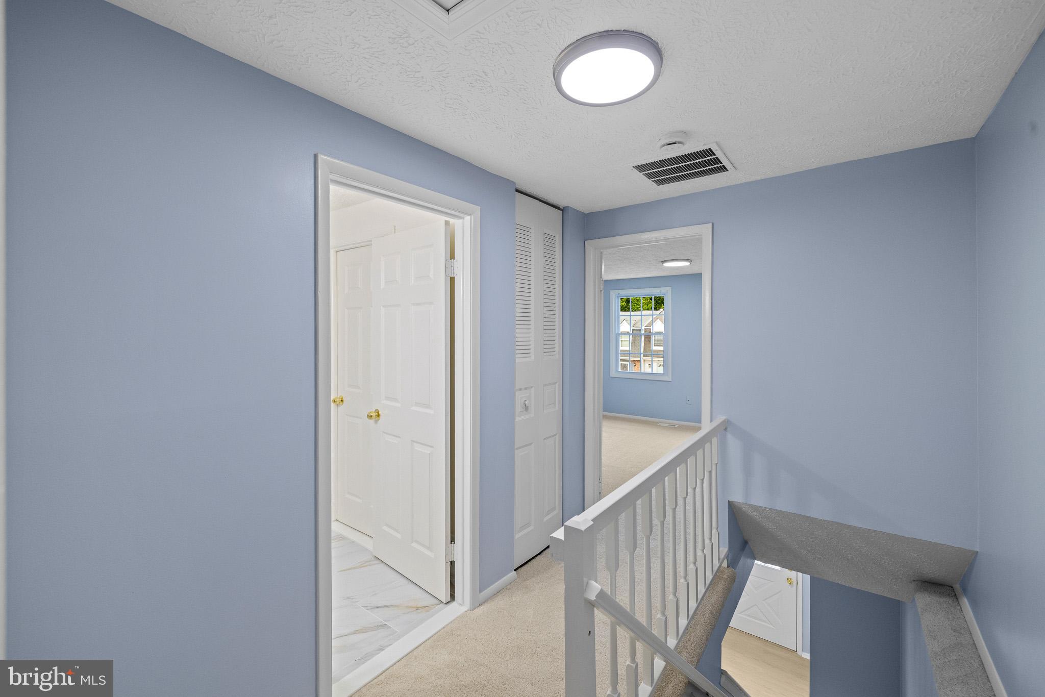 8318 Brookvale Court Springfield, VA 22153 - Photo 14 of 39 a view of a hallway with wooden floor
