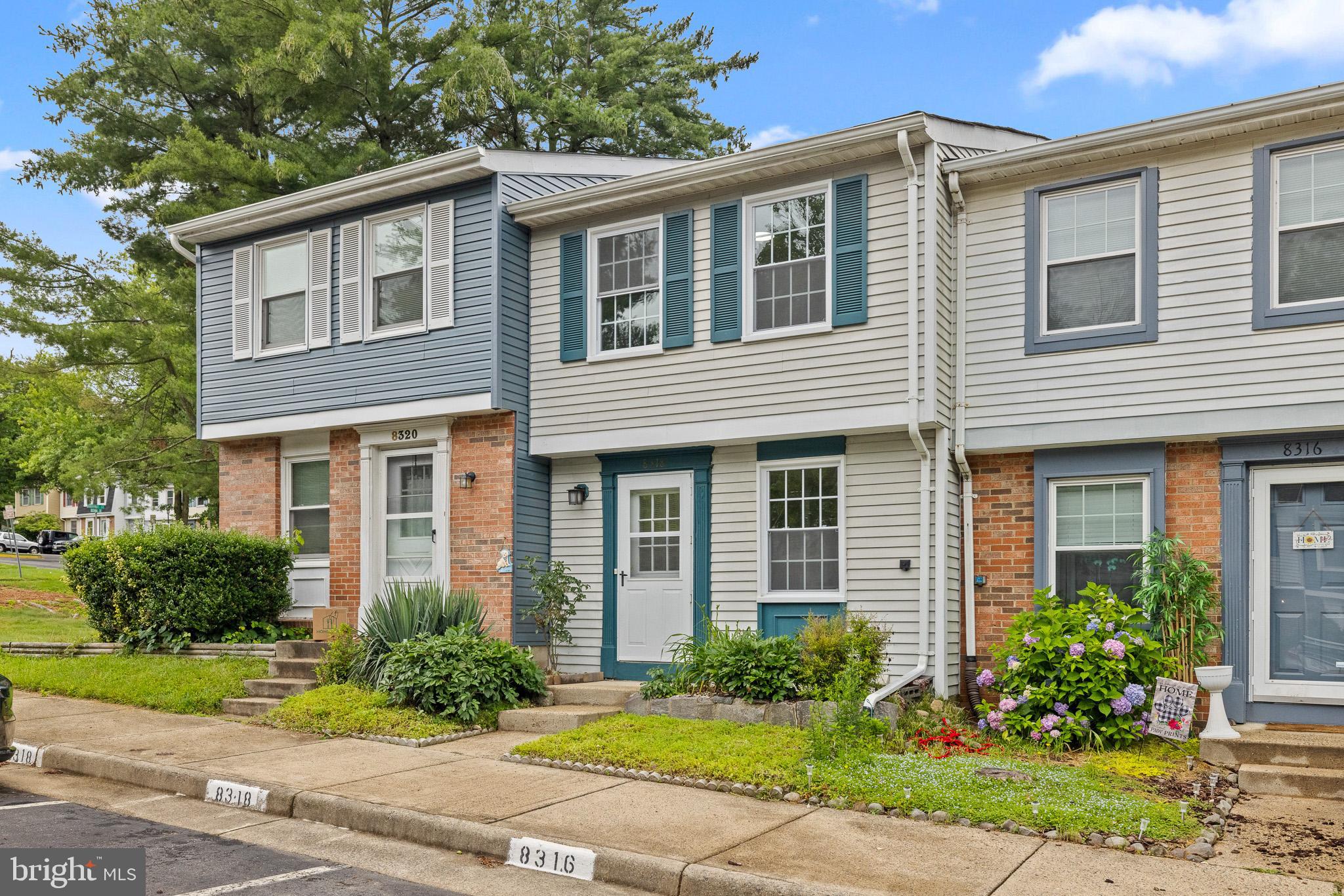 8318 Brookvale Court Springfield, VA 22153 - Photo 2 of 39 a front view of a house with garden and plants
