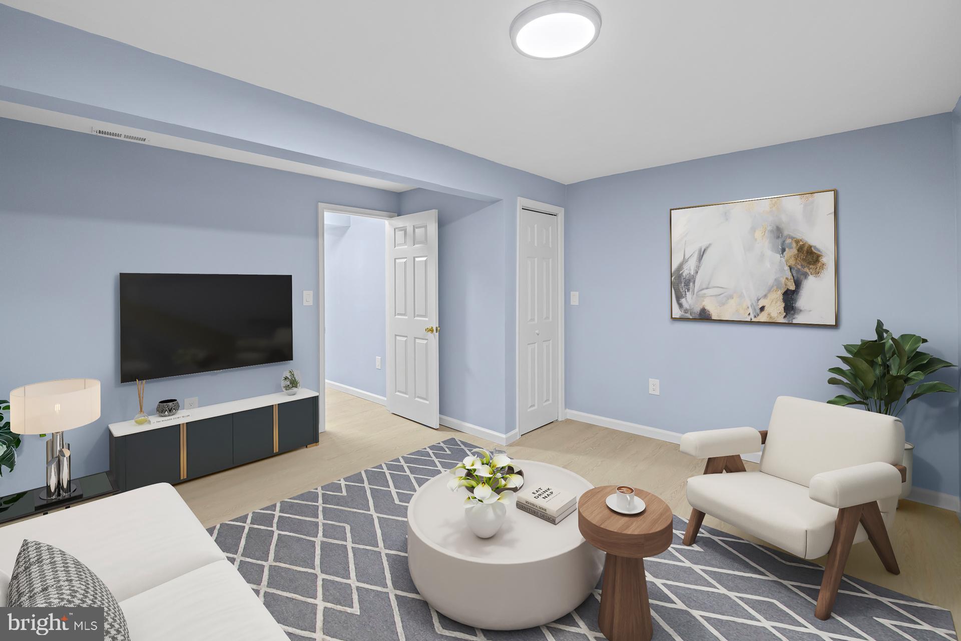 8318 Brookvale Court Springfield, VA 22153 - Photo 32 of 39 a living room with furniture and a flat screen tv