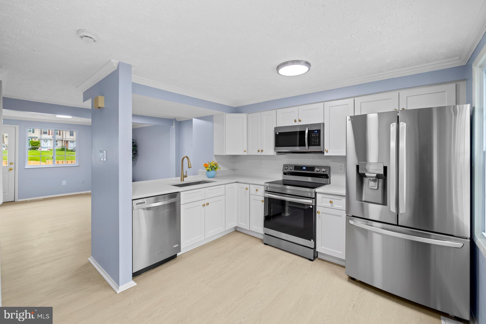 8318 Brookvale Court Springfield, VA 22153 - Photo 6 of 39 a kitchen with stainless steel appliances granite countertop a refrigerator stove and microwave