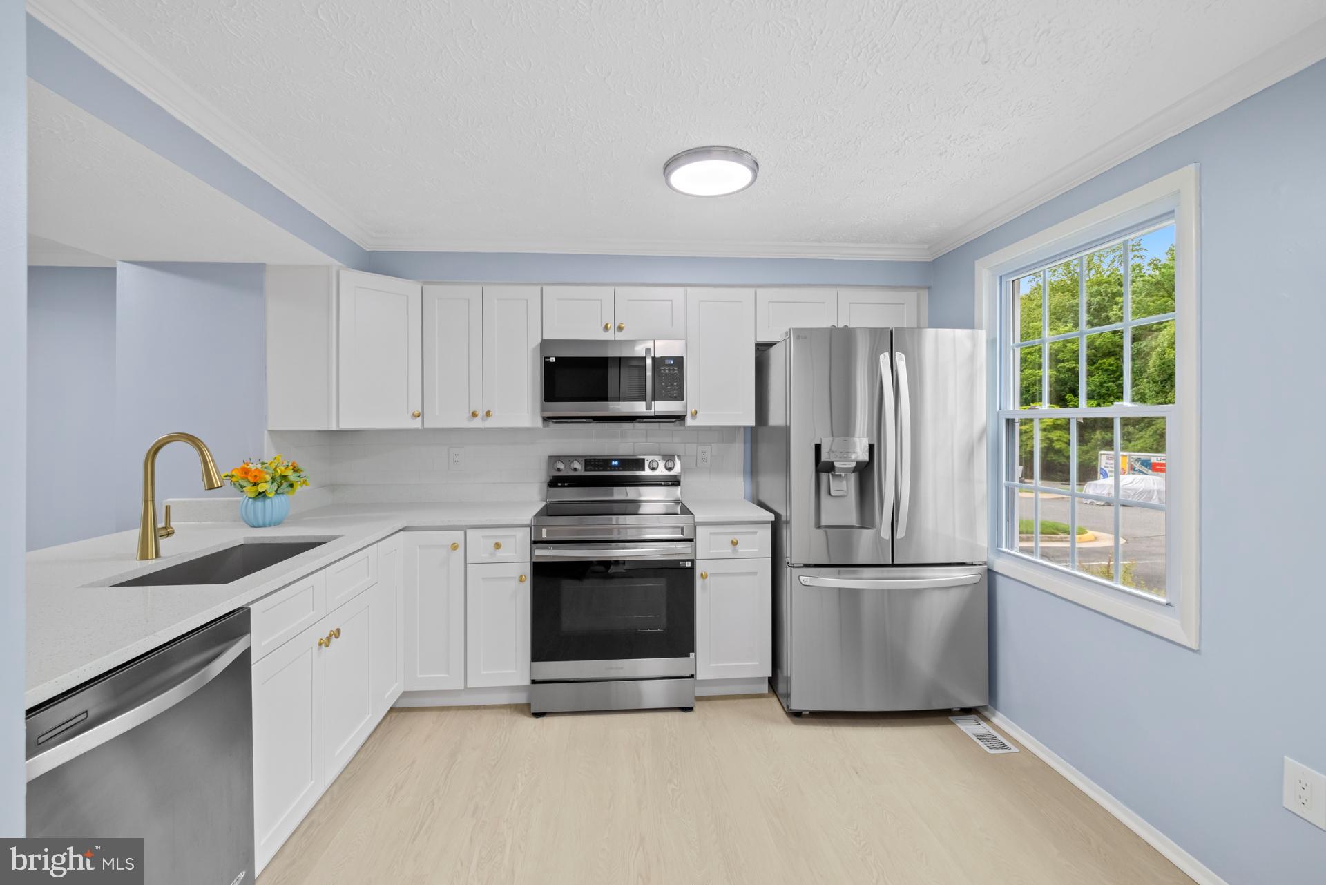 8318 Brookvale Court Springfield, VA 22153 - Photo 7 of 39 a kitchen with stainless steel appliances a refrigerator sink and microwave