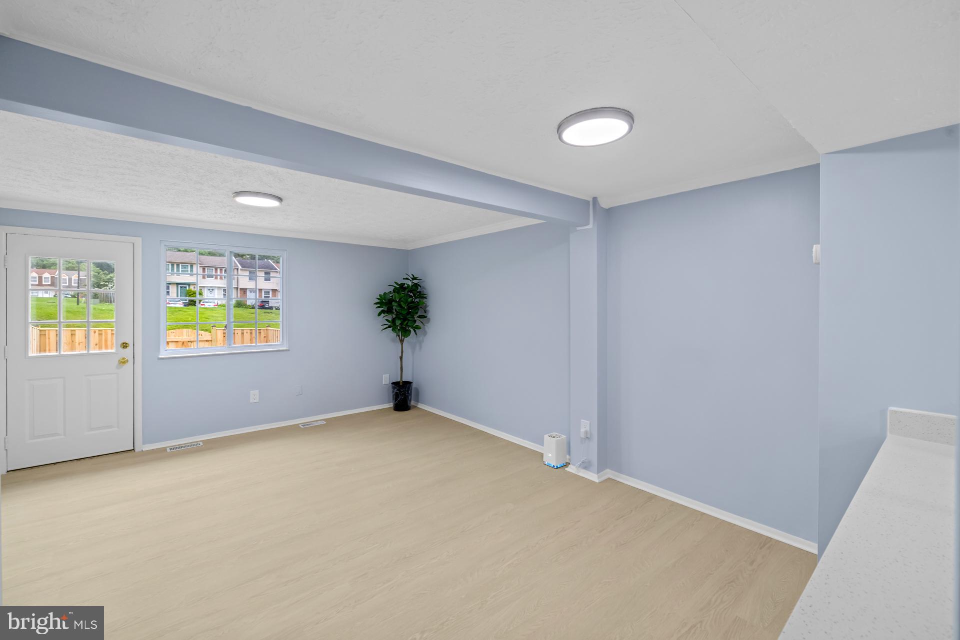 8318 Brookvale Court Springfield, VA 22153 - Photo 9 of 39 an empty room with windows and flower pot