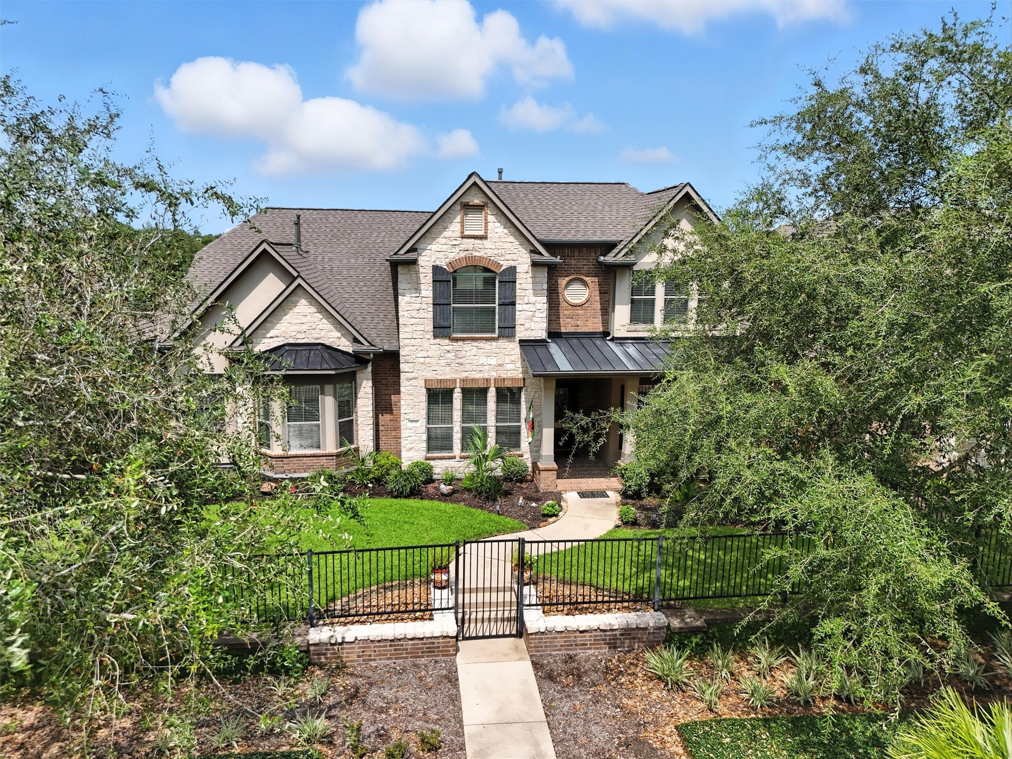 529 Water Street Webster, TX 77598 - Photo 1 of 38 a front view of a house with a yard and potted plants