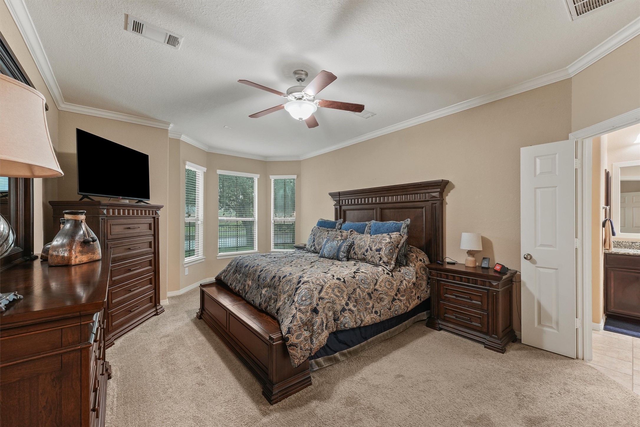 529 Water Street Webster, TX 77598 - Photo 16 of 38 a bedroom with a bed and a flat screen tv