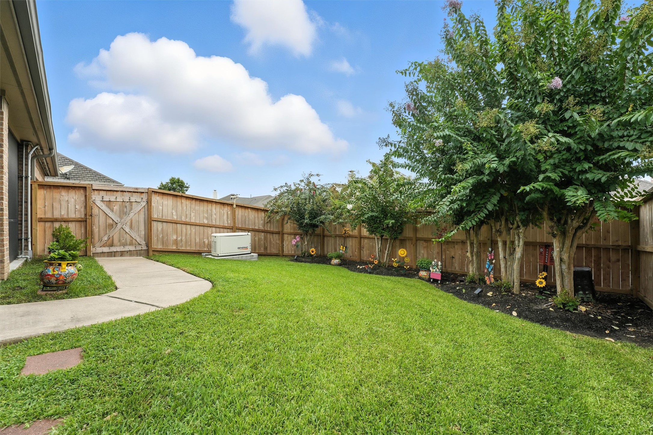 529 Water Street Webster, TX 77598 - Photo 27 of 38 A nice walkway out of the porch towards the driveway for convenience.