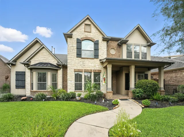 an aerial view of residential houses with outdoor space and lake view