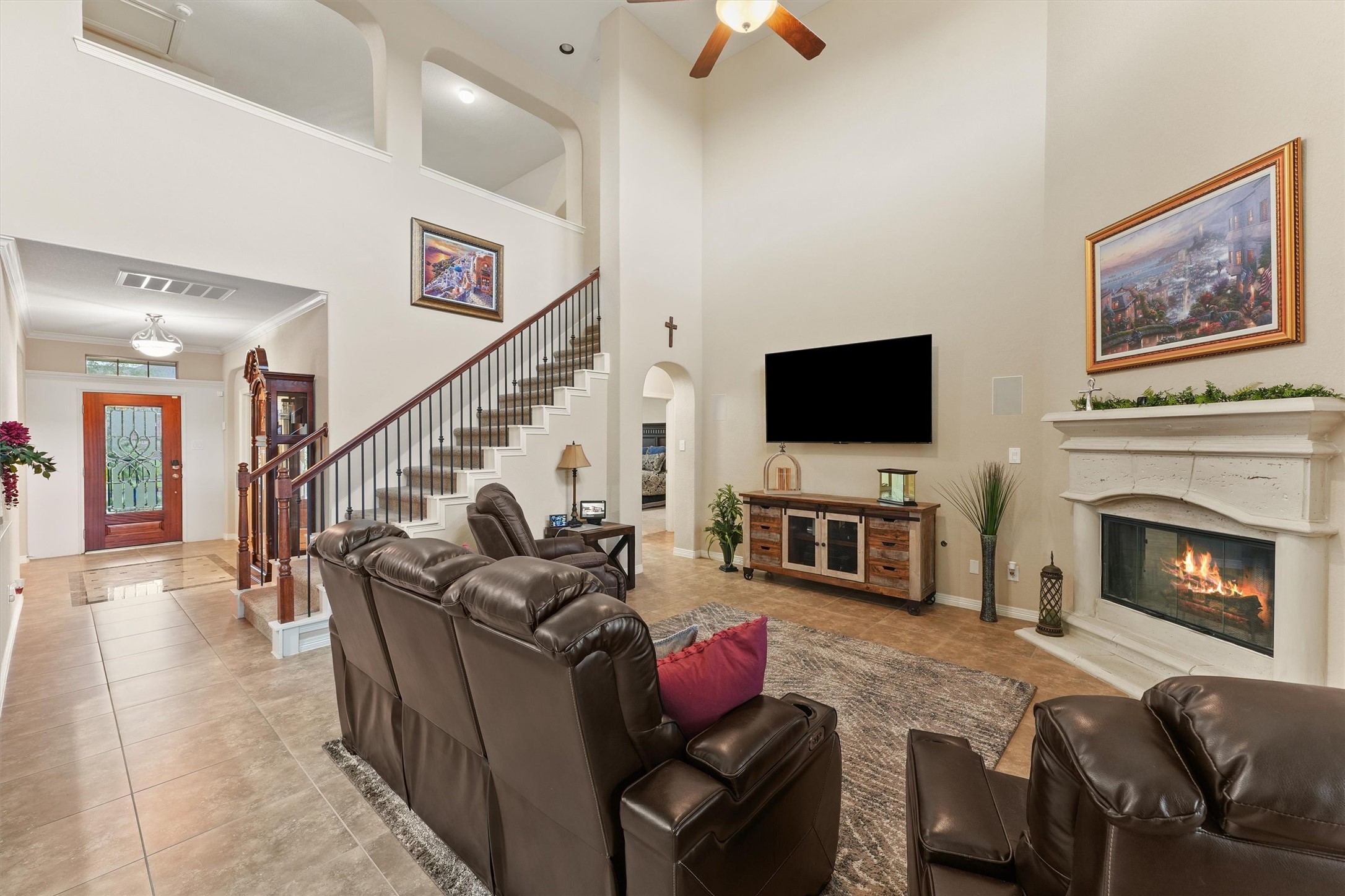 529 Water Street Webster, TX 77598 - Photo 4 of 38 a living room with furniture a flat screen tv and a fireplace