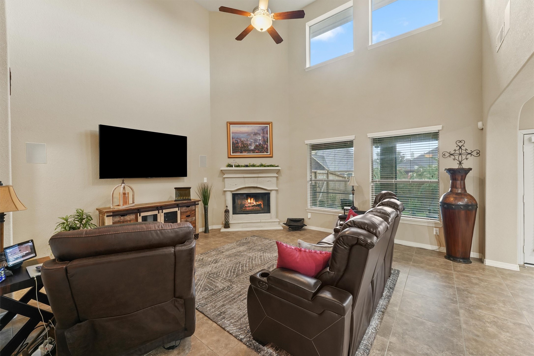 529 Water Street Webster, TX 77598 - Photo 10 of 38 a living room with furniture a flat screen tv and a fireplace