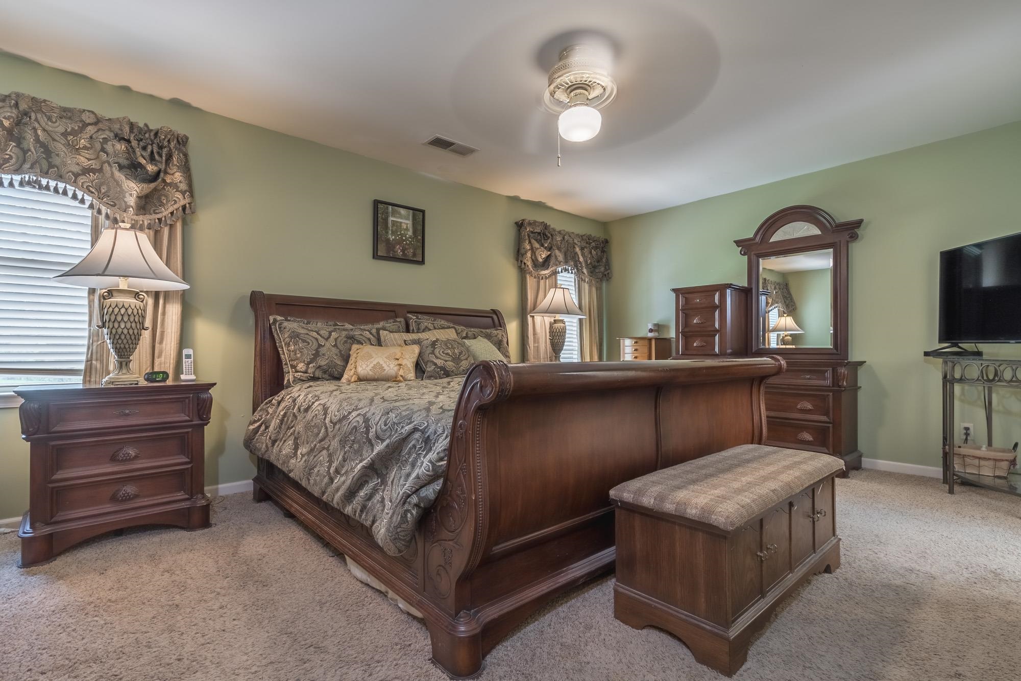 132 South Walnut Bend Road Memphis, TN 38018 - Photo 12 of 23 a bedroom with a bed and a flat tv screen on dresser