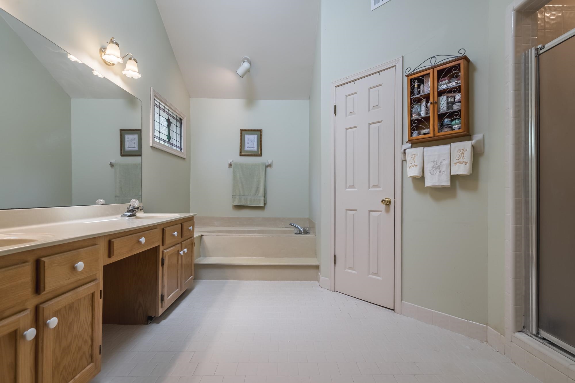 132 South Walnut Bend Road Memphis, TN 38018 - Photo 13 of 23 a spacious bathroom with a tub sink and mirror