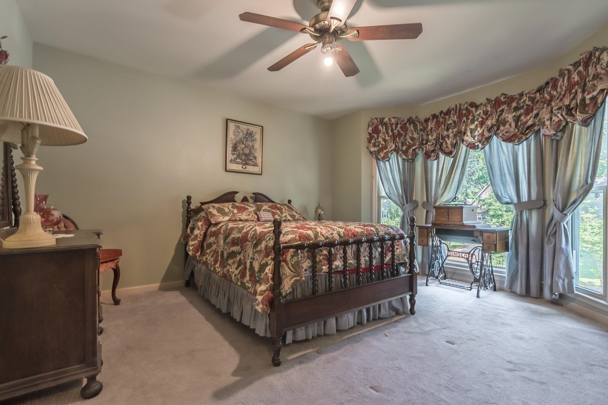 132 South Walnut Bend Road Memphis, TN 38018 - Photo 14 of 23 a bedroom with a bed and a chandelier