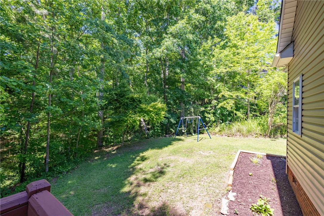 110 Brookstone Way Central, SC 29630 - Photo 19 of 46 This spacious yard features lush greenery, offering a private outdoor retreat for leisure and recreation.