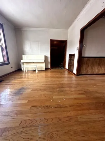 a view of a livingroom with an empty space and a window
