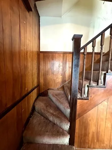 a view of empty room with wooden floor and window