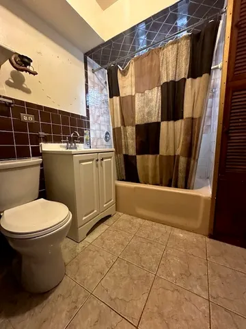 a kitchen with granite countertop a refrigerator and a stove top oven